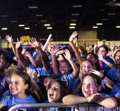 School-age children cheering while attending a Digital Vibez event during summer 2024.