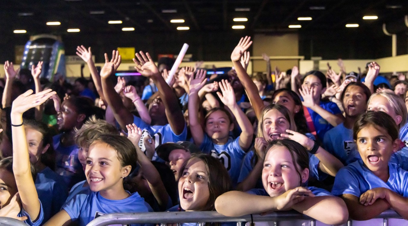 School-age children cheering while attending a Digital Vibez event during summer 2024.