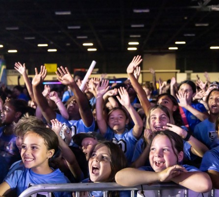 School-age children cheering while attending a Digital Vibez event during summer 2024.