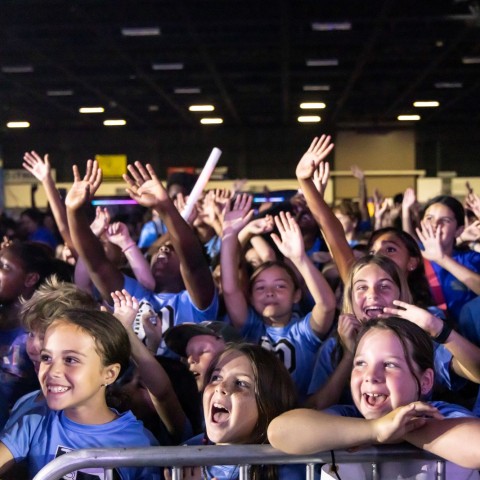 School-age children cheering while attending a Digital Vibez event during summer 2024.